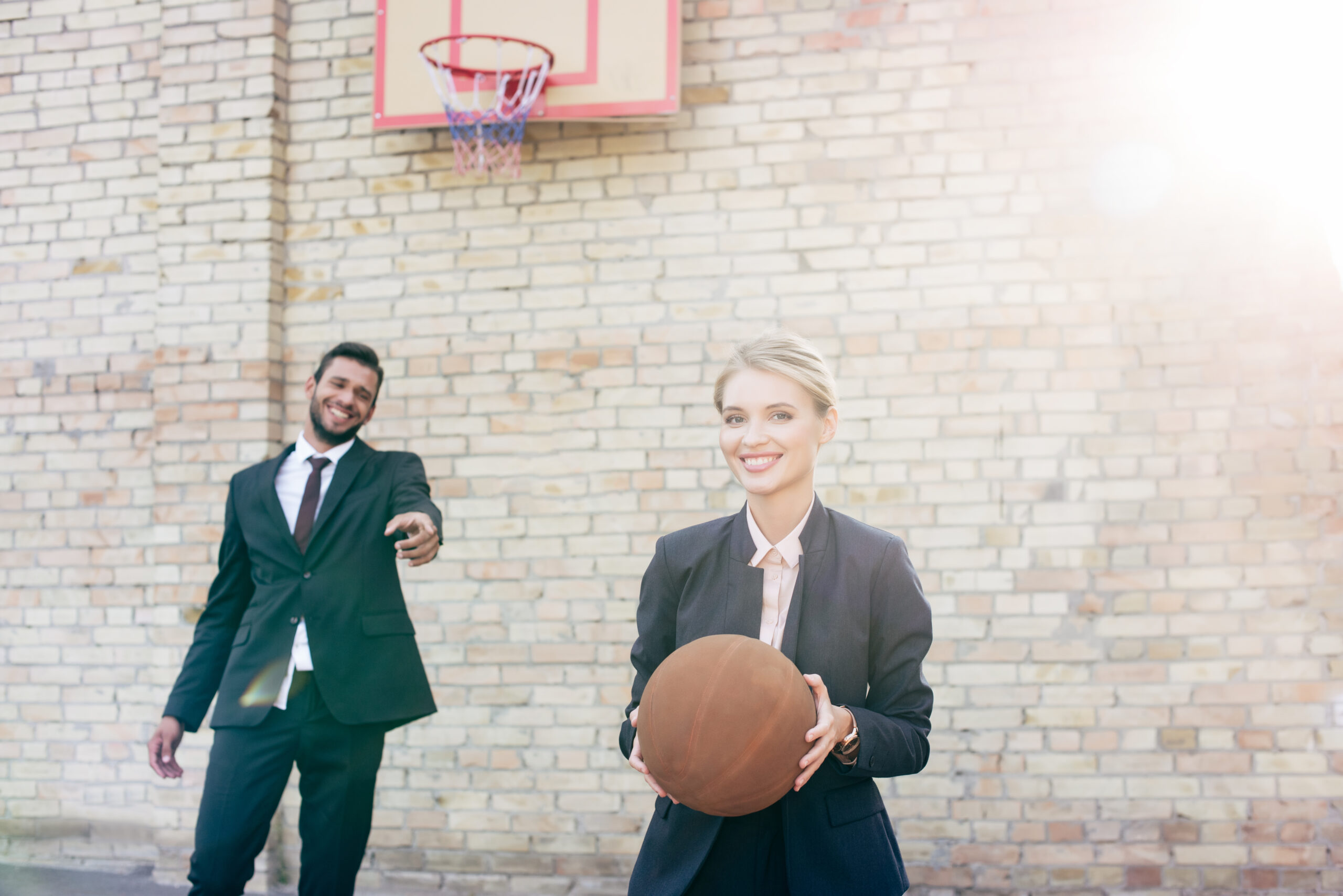 Business people having fun playing basketball